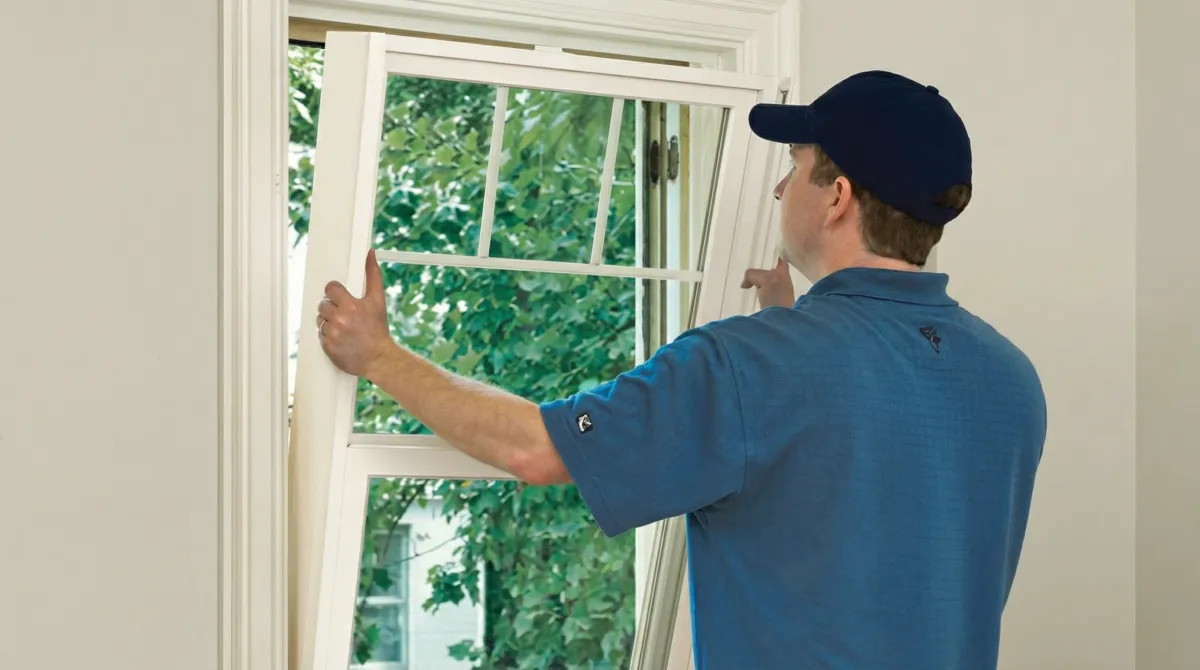 Professional contractors performing a residential window insulation and replacement service in Louisville, KY